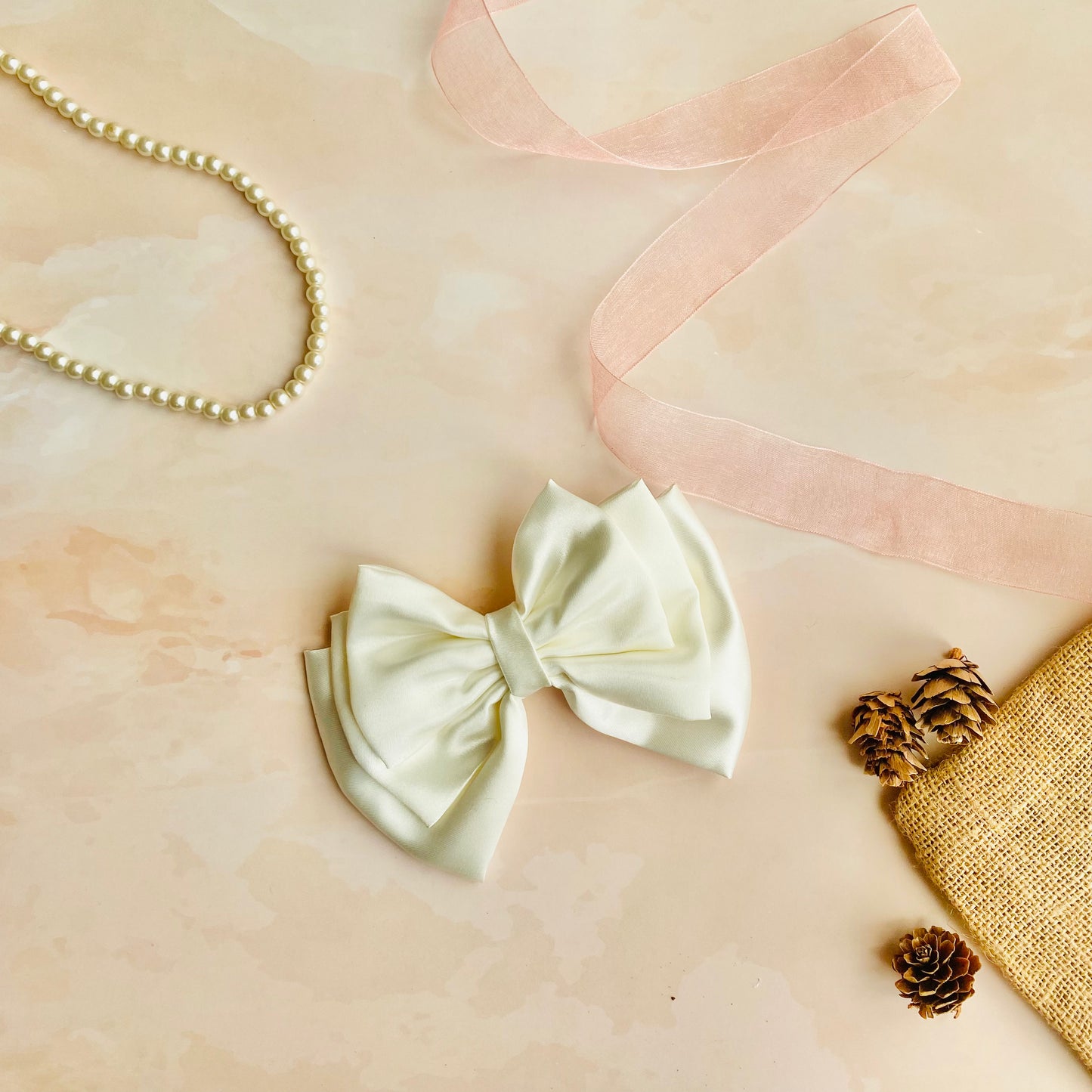 White Triple Layer Hair Bow by RedBerry Cuddle. A classic and elegant hair accessory featuring a triple-layered bow design in a crisp white shade, crafted from high-quality fabric for a secure and sophisticated look.