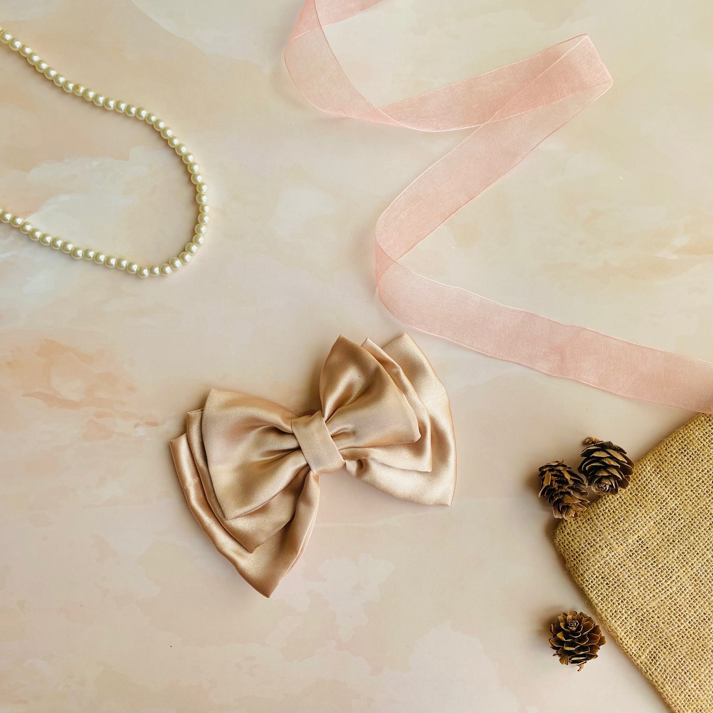 Rose Gold Triple Layer Hair Bow by RedBerry Cuddle. An elegant and stylish hair accessory featuring a triple-layered bow design in a shimmering rose gold shade, crafted from high-quality fabric for a secure and luxurious look.