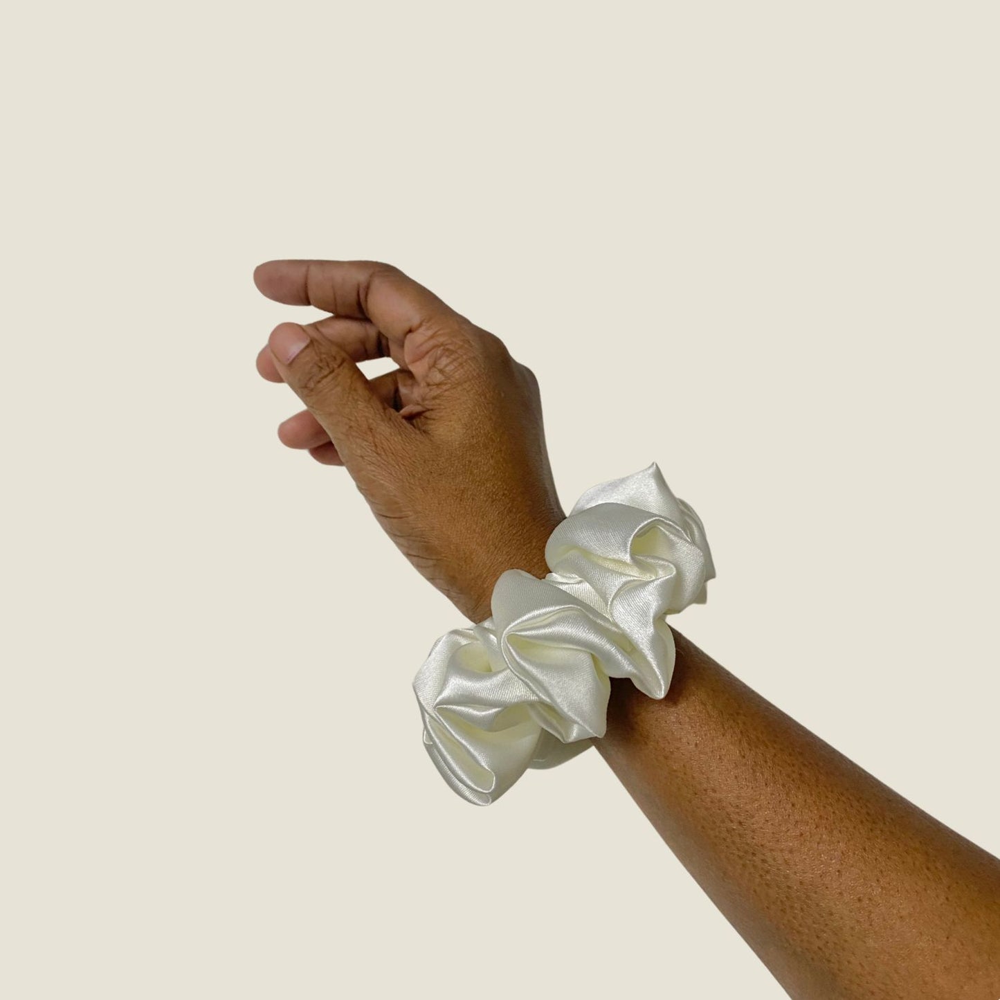 White Scrunchie in medium size by RedBerry Cuddle. A classic, soft white hair accessory with a plush texture, offering a secure and comfortable hold.