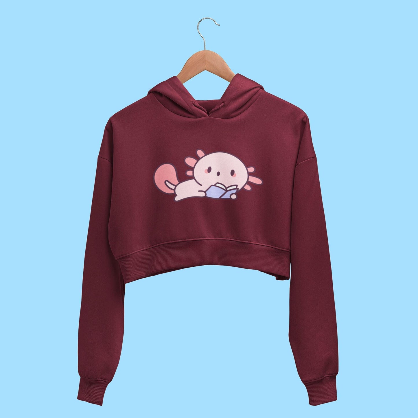 Cute Reader Women's Crop Hoodie by RedBerry Cuddle, featuring a whimsical 'Cute Reader' design. This cozy hoodie combines comfort and style, perfect for book lovers.