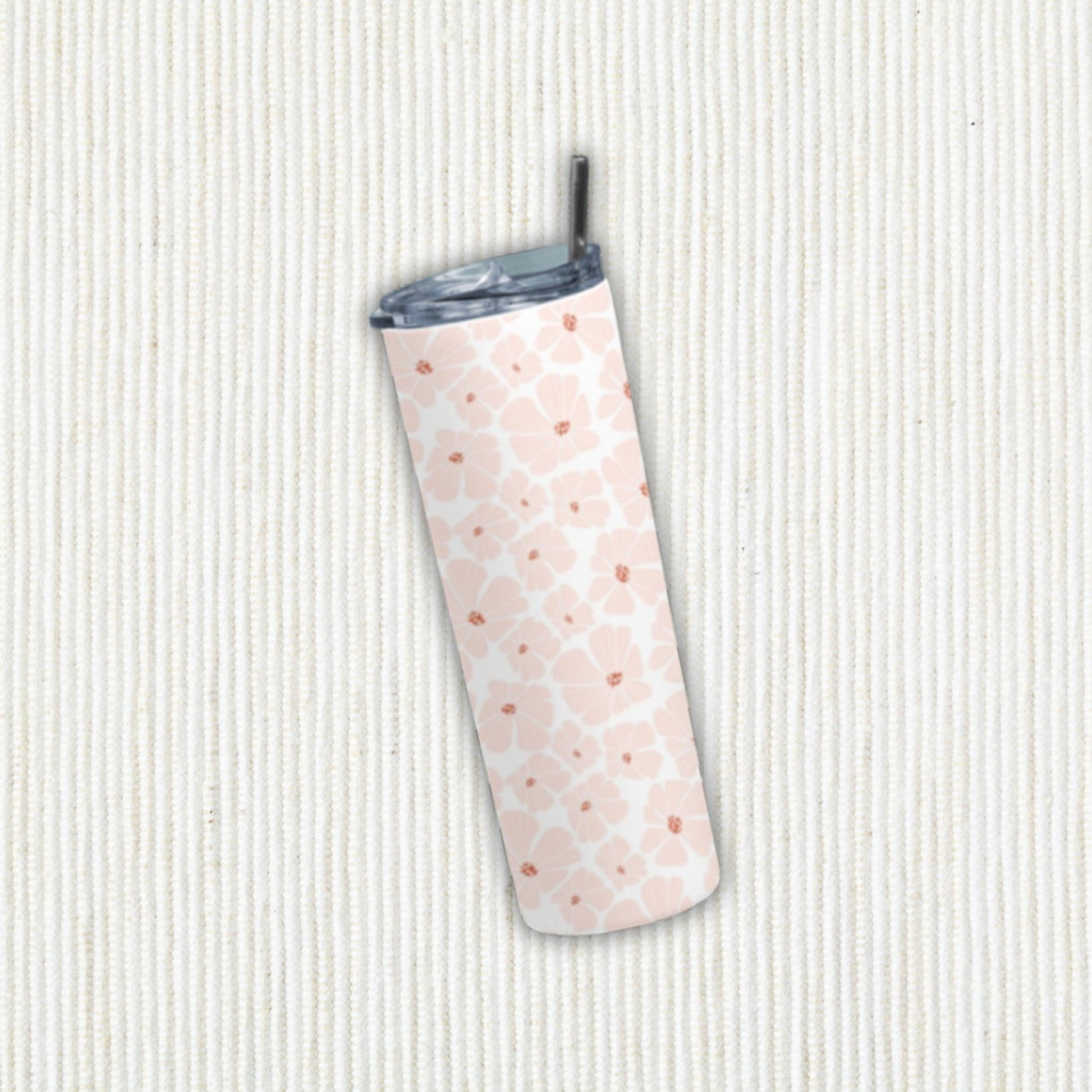 Flower Doodle Tumbler Bottle by RedBerry Cuddle, a 20 oz stainless steel tumbler with a metal straw. It features a playful flower doodle design, double wall insulation, and a splash-proof lid.