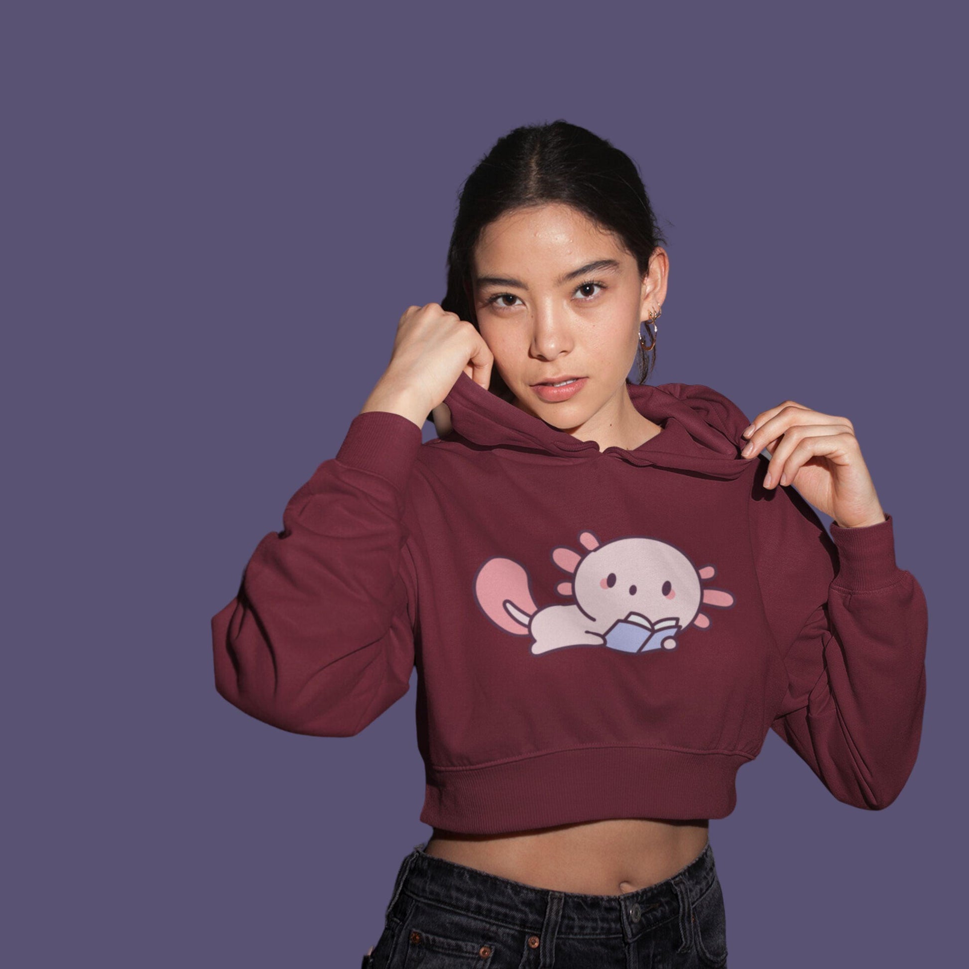 Cute Reader Women's Crop Hoodie by RedBerry Cuddle, featuring a whimsical 'Cute Reader' design. This cozy hoodie combines comfort and style, perfect for book lovers.