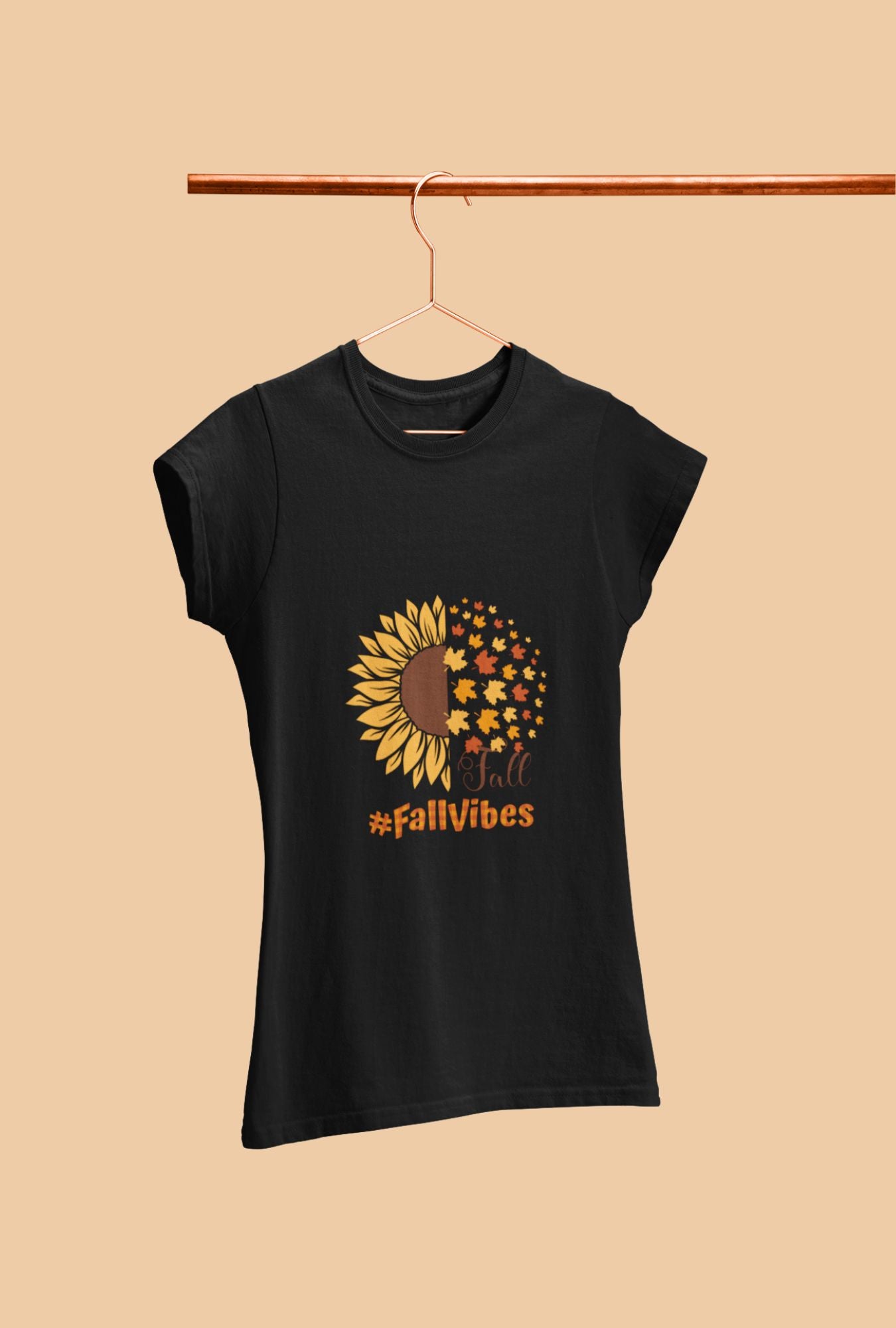 A woman wearing a RedBerry Cuddle 'Fall Vibes' Women's T-Shirt, made of 100% cotton. The black shirt features a sunflower graphic transitioning into autumn leaves with the words 'Fall' and '#FallVibes' in warm, autumnal colors.