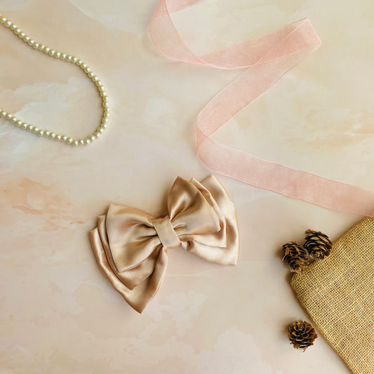 Rose Gold Triple Layer Hair Bow by RedBerry Cuddle. An elegant and stylish hair accessory featuring a triple-layered bow design in a shimmering rose gold shade, crafted from high-quality fabric for a secure and luxurious look.