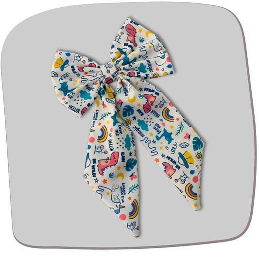 Magic Doodle Midi Tail Hair Bow by RedBerry Cuddle. A playful and stylish hair accessory featuring a midi-length bow with a whimsical doodle-inspired design, crafted from soft, high-quality fabric for a secure and charming look.